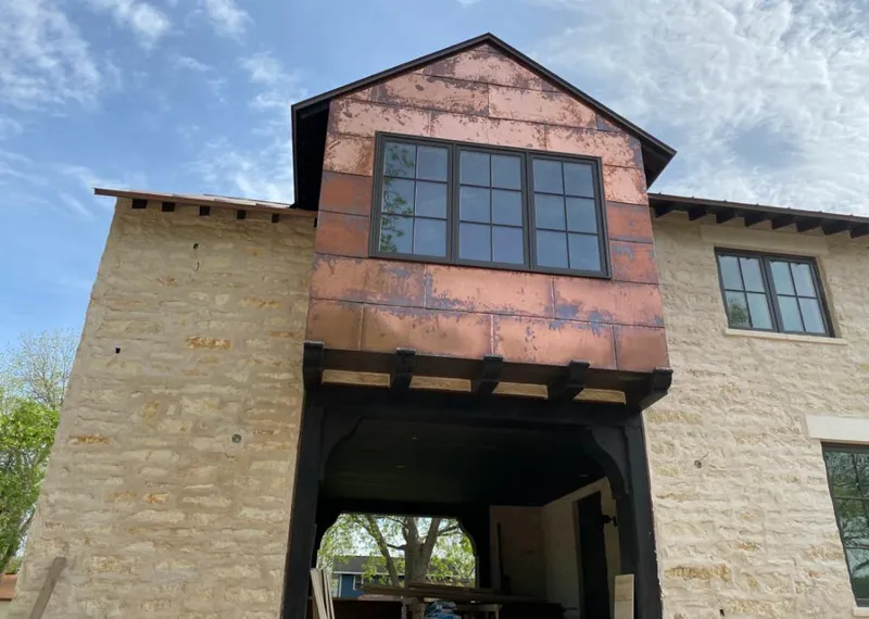 Copper metal panel facade on a stone building for Skylight Installation in Stallings